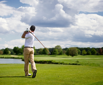 Golf player teeing off